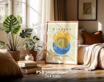 May include: A framed poster with a geometric design in yellow, blue, and white. The poster has the text "Bauhaus Ausstellung" on it. The poster is leaning against a white couch with a brown throw blanket.
