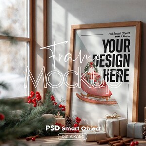 May include: A framed print with a Christmas theme, featuring a watercolor illustration of a sled carrying gifts. The frame is made of light-colored wood. Text on the print reads "YOUR DESIGN HERE". The scene includes festive decorations.