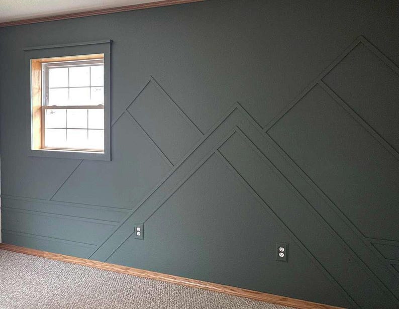 May include: A dark gray wall with a geometric pattern of raised lines creating a mountain range design. The wall has two electrical outlets and a window with white trim.