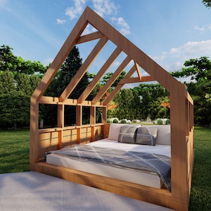 May include: A wooden outdoor bed frame with a grey and white patterned blanket. The bed is surrounded by green grass and trees.