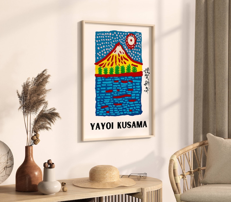 May include: A framed art print featuring a colorful illustration of a mountain landscape with the text "YAYOI KUSAMA". The artwork has a red, yellow, and blue color scheme, with Japanese text on the right side.