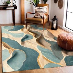 May include: A rectangular area rug with a flowing, abstract design in shades of teal, beige, and gold. The rug features a wavy pattern, creating a sense of depth and movement. The rug is placed on a wooden floor.