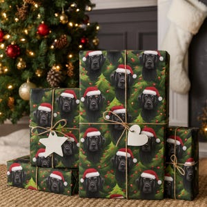 May include: Christmas-themed gift wrap featuring a repeating pattern of black Labrador Retrievers wearing Santa hats, set against a backdrop of green Christmas trees. The gifts are tied with twine and adorned with decorative tags.