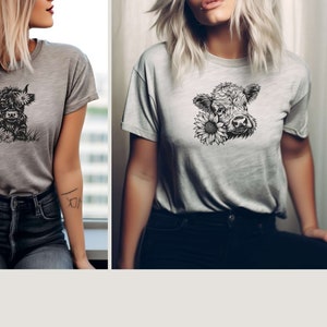 May include: Two women wearing gray t-shirts with a black and white illustration of a Highland cow with flowers on the front.