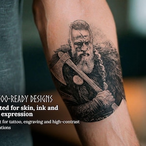 May include: A black and white tattoo design of a Viking warrior with an axe, on an arm. The tattoo is detailed with a beard, fur, and a battle scar. Text on the image reads "TATTOO-READY DESIGNS Crafted for skin, ink and bold expression."