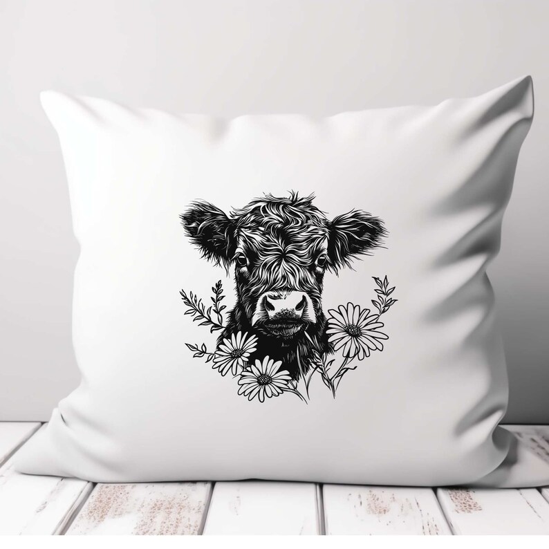 May include: Black and white illustration of a cow's head with flowers around it. The cow has a fluffy, curly coat and is looking directly at the viewer. The flowers are simple daisies.