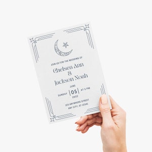 May include: A wedding invitation with a blue crescent moon and star design. The invitation reads "Join us for the wedding of Chelsea Ann & Jackson Noah, Sunday June 05, 2022 at 5 PM, 123 Anywhere Street, Any City, ST 12345."