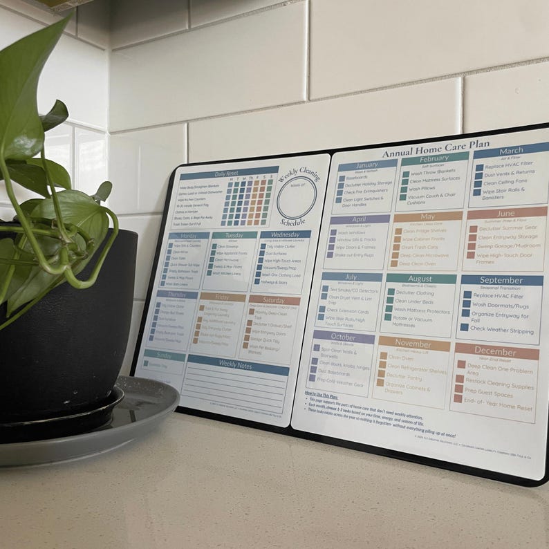 May include: A home care plan in black and white, featuring a weekly cleaning schedule and an annual plan. The plan details monthly tasks like cleaning appliances and changing filters. A potted plant is in the foreground.