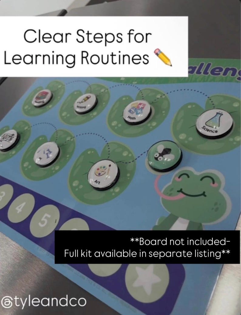 May include: A blue educational board game with the text "Clear Steps for Learning Routines." The game features circular magnets with subject icons like math and science, placed on lily pads. A cartoon frog is on the right side of the board.