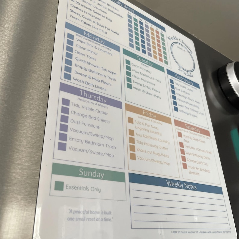 May include: A white magnetic cleaning schedule with a weekly layout. It features daily tasks, a calendar, and a section for weekly notes. The schedule includes tasks like cleaning the kitchen, bathrooms, and bedrooms.