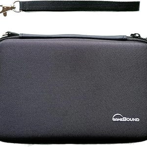 May include: A black zippered carrying case with a wrist strap and a metal clasp. The case has a textured surface and the word "GAMEBOUND" printed in white on the lower right corner. The wrist strap is black.