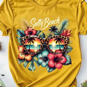 May include: A yellow t-shirt with a graphic of sunglasses with a beach scene reflected in the lenses. The sunglasses are surrounded by tropical flowers and leaves. The text "Salty Beach" is printed above the sunglasses.