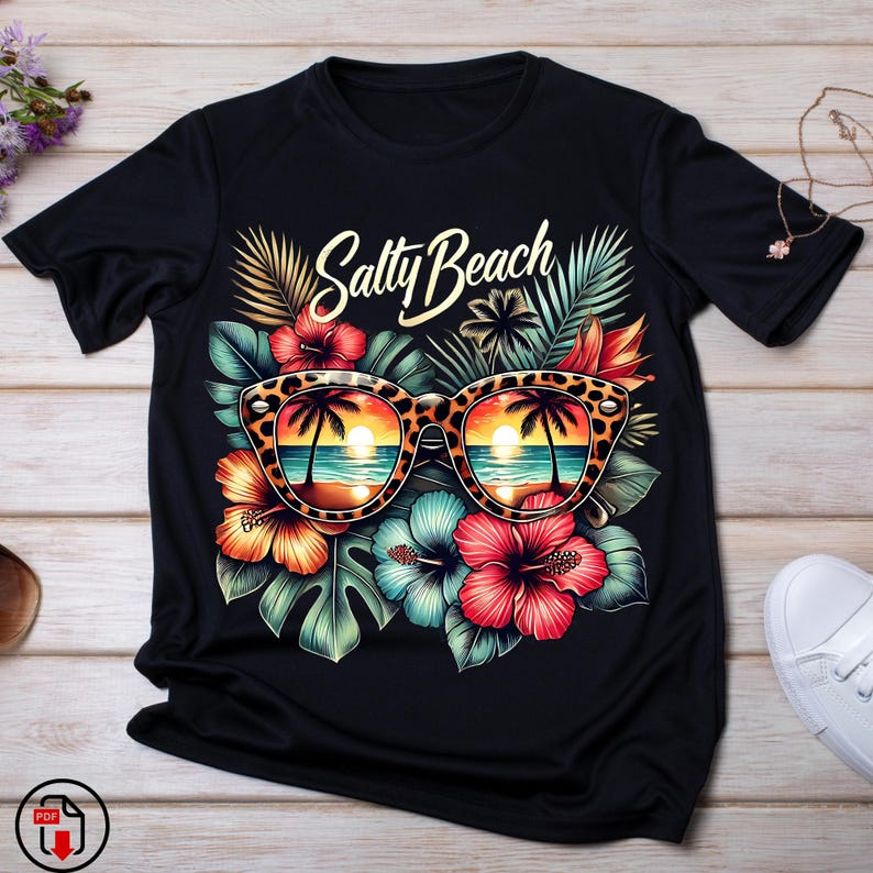 May include: Black t-shirt with a tropical print featuring a pair of sunglasses with a sunset reflection, palm trees, and the text "Salty Beach".