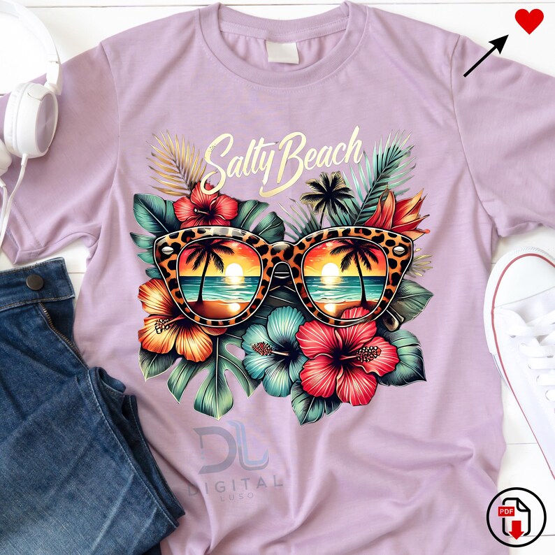 May include: A purple t-shirt with a graphic design of sunglasses with a beach scene reflected in the lenses. The sunglasses are surrounded by tropical flowers and leaves. The text "Salty Beach" is printed in gold above the sunglasses.