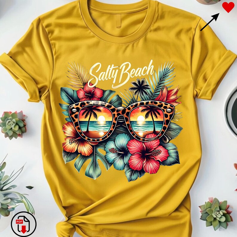 May include: A yellow t-shirt with a graphic of sunglasses with a beach scene reflected in the lenses. The sunglasses are surrounded by tropical flowers and leaves. The text "Salty Beach" is printed above the sunglasses.