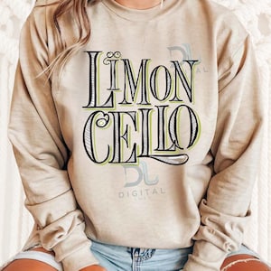 Pode incluir: Uma camisa de moletom bege com o texto "LIMONCELLO" em letras pretas e verdes. O texto é estilizado com uma borda decorativa.