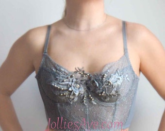 A gray pearl-colored lingerie top with lace flowers and a vintage corset style