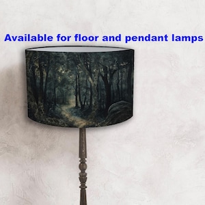 May include: A floor lamp with a lampshade depicting a dark forest scene. The lampshade shows a path through tall trees, with the text "Available for floor and pendant lamps" in blue.