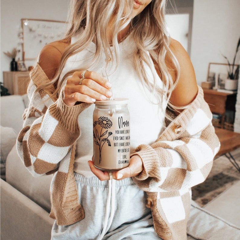 May include: A clear glass jar with a straw and a lid. The jar has a floral design and the text "Mom You have loved me ever since I was born but I have loved my entire life Love, Evan/Ava" printed on it.