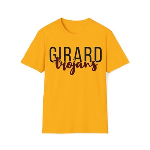 May include: Mustard yellow t-shirt with the text "GIRARD Trojans" printed across the front. The word "GIRARD" is in a bold, black font, and "Trojans" is in a cursive, maroon font.