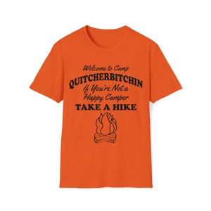 May include: Orange t-shirt with black text that reads "Welcome to Camp Quitchebitchin If You're Not a Happy Camper TAKE A HIKE" and a graphic of a campfire. The shirt is a crew neck style.