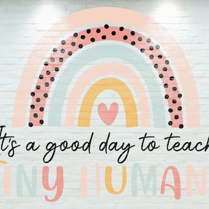 May include: A colorful rainbow with black polka dots and a pink heart in the center. The text "It's a good day to teach TINY HUMANS" is written below the rainbow.