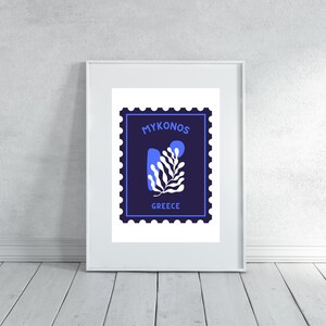 May include: A blue and white illustration of a stylized plant on a navy blue background with the text "MYKONOS GREECE" inside a white frame.