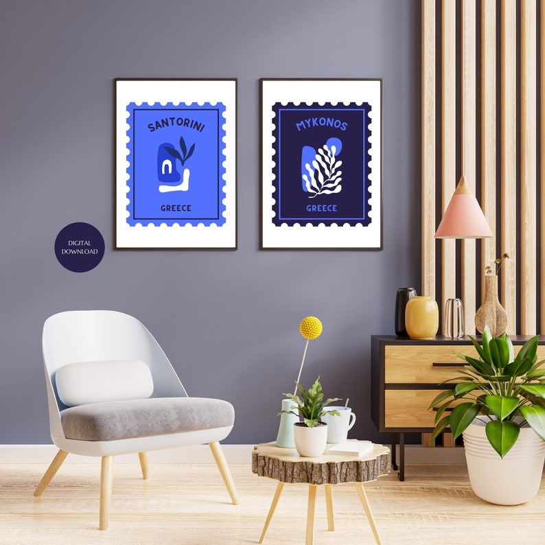 May include: Two digital prints of blue and white stamps with the words "Santorini Greece" and "Mykonos Greece" on a gray wall in a living room setting.