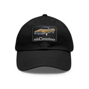 May include: Black baseball cap with a brown and gold El Camino car patch. The patch features the text "el Camino" in silver lettering.