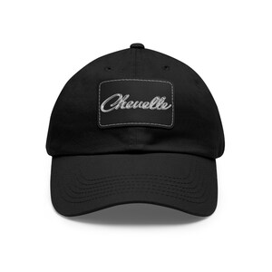 May include: Black cotton baseball cap with a white embroidered patch that says "Chevelle" in a script font.