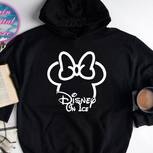 May include: Black hooded sweatshirt with a white outline of Mickey Mouse's head with a bow and the text "Disney On Ice".