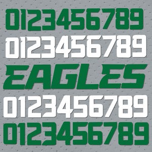 Könnte beinhalten: Grüne und weiße Zahlen 0123456789, mit dem Wort "EAGLES" in Grün, auf grauem Hintergrund.