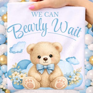 Op de afbeelding: Een witte babyborrel aankondiging met een cartoon teddybeer met een blauwe vlinderdas. De tekst "WE CAN Bearly Wait" is in blauwe letters boven de beer geschreven. Blauwe wolken en bloemen omringen de beer.