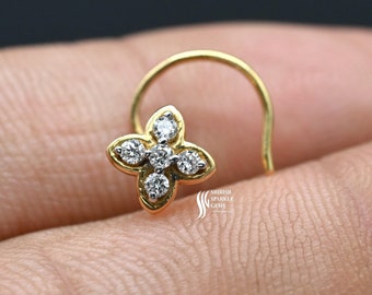 May include: A gold nose ring with a flower design featuring five small diamonds.