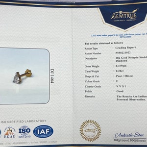May include: A Gemtrue grading report for a 18k gold nosepin studded with a lab-grown diamond. The report details the diamond's weight, shape, color, clarity, and polish. The report number is P558221022.
