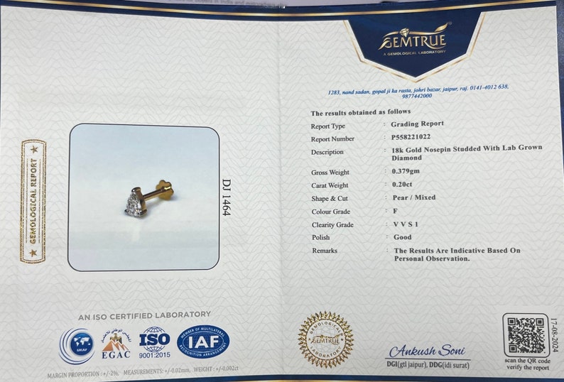 May include: A Gemtrue grading report for a 18k gold nosepin studded with a lab-grown diamond. The report details the diamond's weight, shape, color, clarity, and polish. The report number is P558221022.