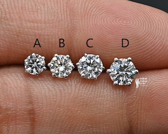 May include: Four round, clear, prong-set diamonds of varying sizes labeled A, B, C, and D.