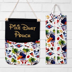 May include: Two fabric pouches. One is black with "Pixie Dust Pouch" in gold glitter. The other is white with a pattern of cruise ships, Mickey Mouse, ice cream cones, and palm trees. Both have a cream-colored background.