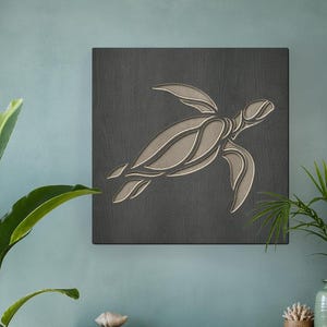 May include: A square, dark gray wooden wall art piece featuring a stylized turtle design in shades of beige and light brown. The artwork is mounted on a light blue wall above a wooden cabinet. The room is decorated with plants and beach-themed decor.