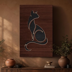 May include: A rectangular wall art piece featuring a dark wood grain background with a stylised, layered cutout of a sitting cat in black. The cat silhouette is outlined with a light-coloured border, creating a dimensional effect on the flat surface.