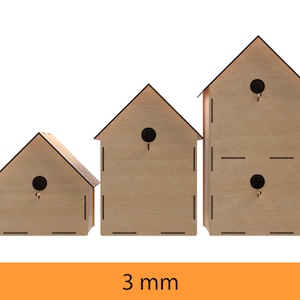 May include: Three wooden birdhouses of different sizes, each with a small hole for birds to enter. The birdhouses are made of light brown wood and have a simple design. The text "3 mm" is printed below the birdhouses.