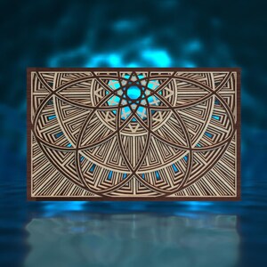 May include: A wooden wall decor with a geometric design featuring a starburst pattern in the center. The design is made up of overlapping circles and squares, creating a complex and intricate pattern.