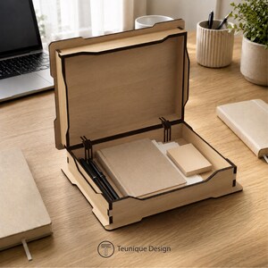May include: A wooden desk organiser with a hinged lid, containing notebooks, sticky notes, and pens. The organiser is made of light-coloured wood with dark brown trim. The logo "Teunique Design" is visible.