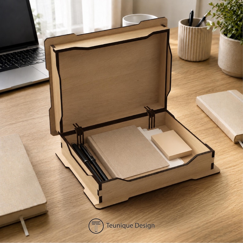May include: A wooden desk organiser with a hinged lid, containing notebooks, sticky notes, and pens. The organiser is made of light-coloured wood with dark brown trim. The logo "Teunique Design" is visible.