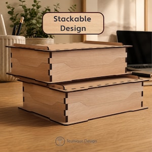 May include: Two stackable wooden boxes with a light brown finish are displayed on a wooden surface. The boxes have a rectangular shape with a unique design. The text "Stackable Design" is visible above the boxes. The logo for "Teunique Design" is at the bottom.