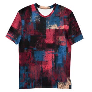 May include: A short-sleeved t-shirt with an abstract design. The shirt features a pattern of overlapping brushstrokes in shades of red, blue, black, and beige. The crew neck shirt has a white interior.