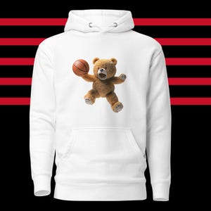 May include: White hoodie with a brown teddy bear wearing a basketball.
