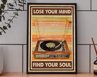May include: A framed vintage-style poster featuring a retro record player with the text "LOSE YOUR MIND FIND YOUR SOUL". The poster has a brown border and a colorful striped background.