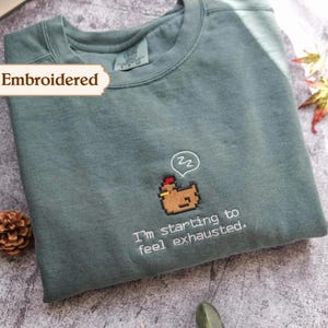I'm Starting To Feel Exhausted embroidered Sweatshirt Stardew Valley, Sleepy Chicken Hoodie, Pixel Art, Gamer Gift, For Him Pelican Town