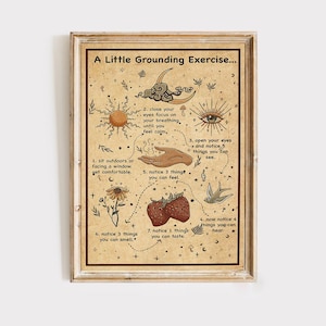 May include: A framed print with the text "A Little Grounding Exercise..." in a vintage style. The artwork features illustrations of a sun, moon, eye, hand, flower, strawberries, and a bird, with instructions for a grounding exercise.
